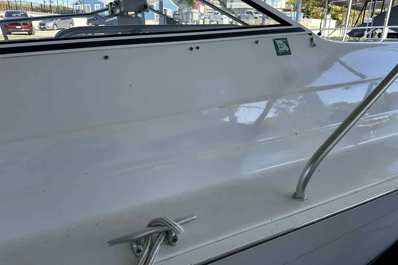 Slide: The Image of 1993 Mainship 39 Express boat side view with railing and cleat. - 13