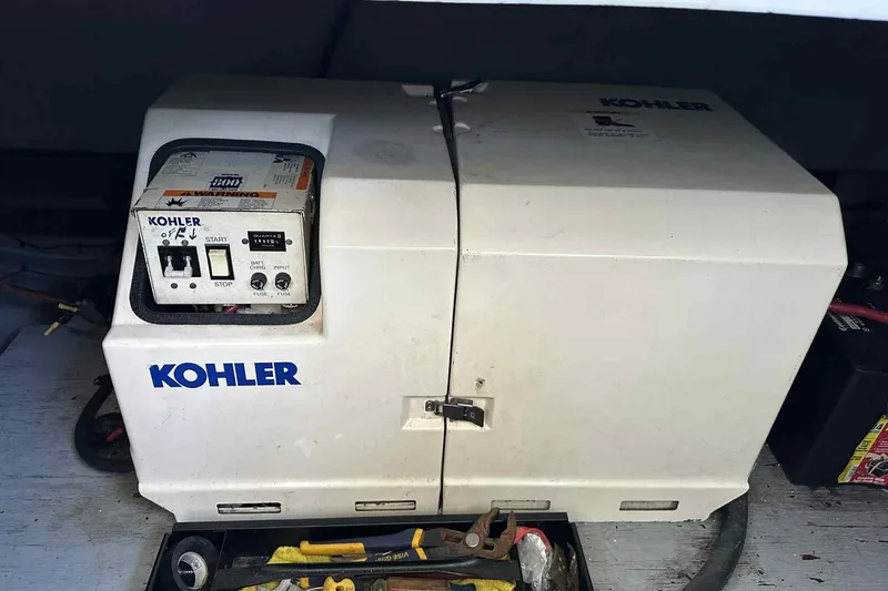 Slide: The Image of Kohler generator on 1993 Mainship 39 Express boat, surrounded by tools. - 17
