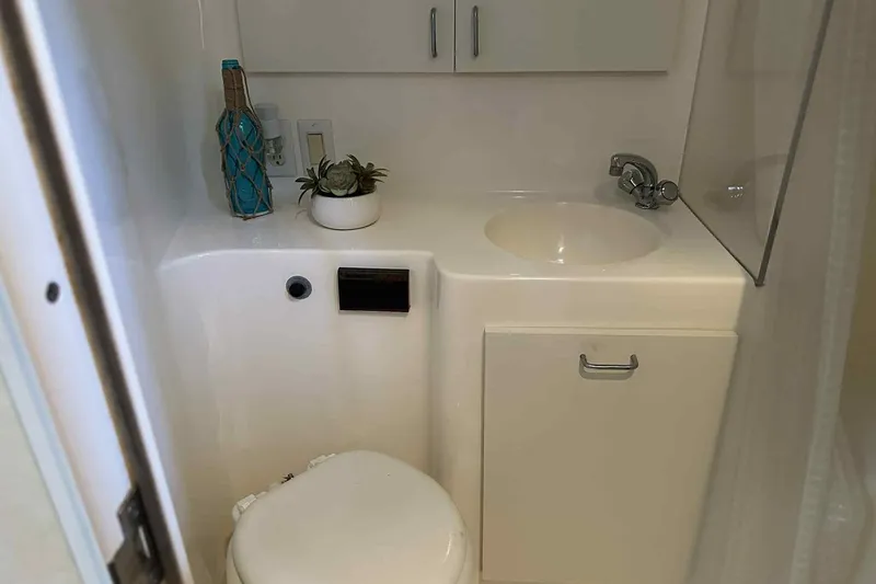 Slide: The Image of Bathroom interior of 1993 Mainship 39 Express yacht with sink and toilet. - 19