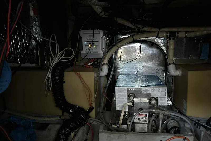 Slide: The Image of Engine room of a 1993 Mainship 39 Express with visible wiring and equipment. - 21