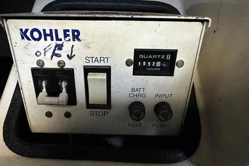 Slide: The Image of Kohler generator control panel on 1993 Mainship 39 Express boat, showing 10520 hours. - 26