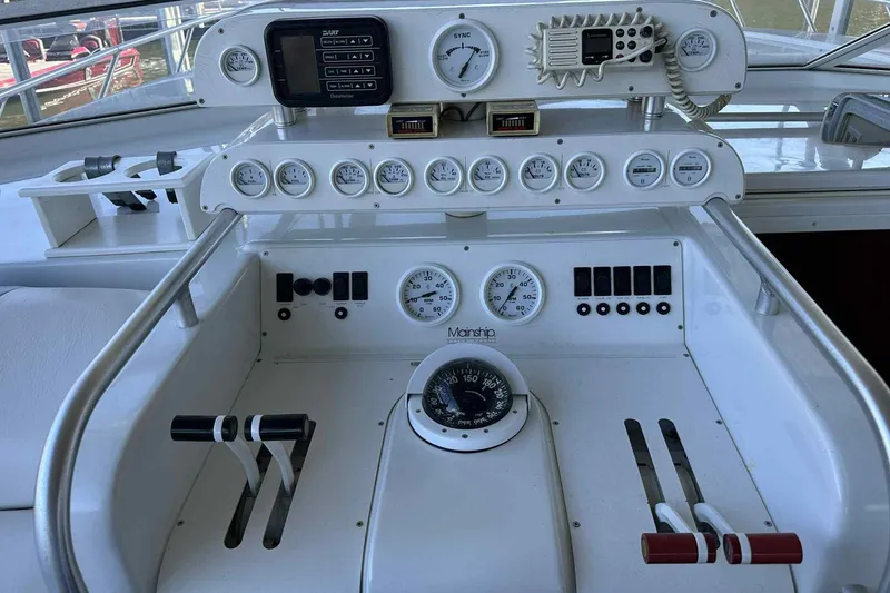 Slide: The Image of 1993 Mainship 39 Express boat dashboard with gauges, controls, and navigation instruments. - 27