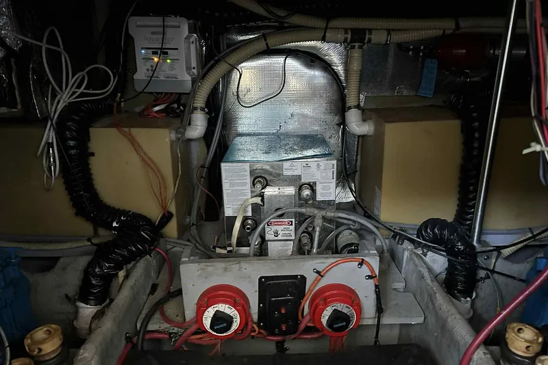Slide: The Image of Engine room of a 1993 Mainship 39 Express boat, showcasing wiring and mechanical components. - 33