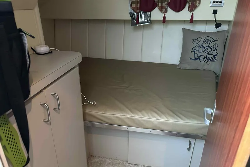 Slide: The Image of Cozy cabin interior of 1993 Mainship 39 Express with bed and storage cabinets. - 36