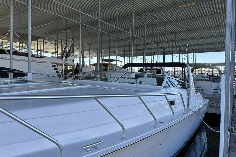 Slide: The Image of 1993 Mainship 39 Express yacht docked in a covered marina, showcasing sleek design. - 39