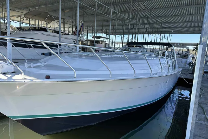 Slide: The Image of 1993 Mainship 39 Express boat docked in a covered marina. - 44