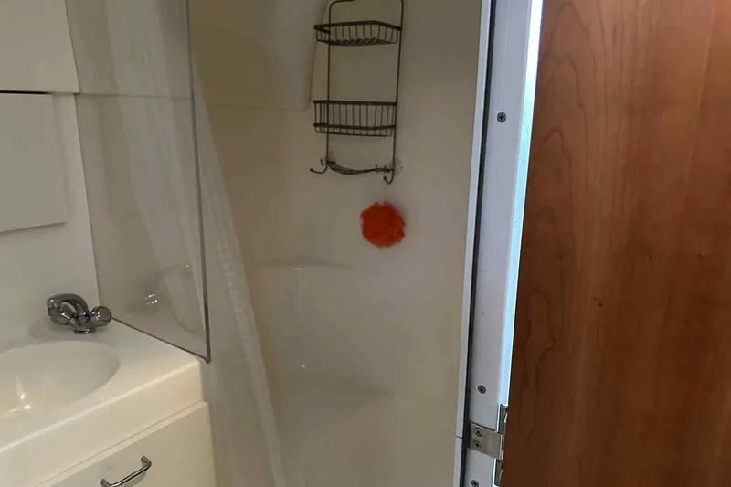 Slide: The Image of Bathroom interior of 1993 Mainship 39 Express yacht with shower and sink. - 8