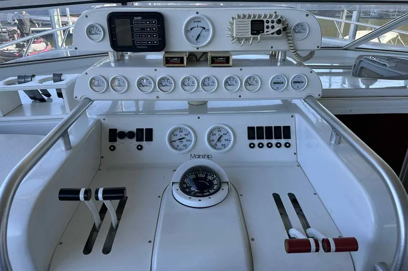 Slide: The Image of 1993 Mainship 39 Express helm with gauges, controls, and navigation instruments. - 9