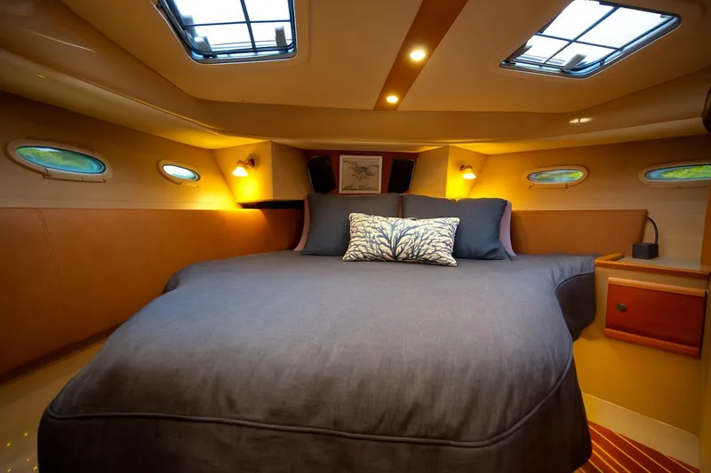 Slide: The Image of Luxurious cabin interior of 2016 Cutwater 30 CB with cozy bed and ambient lighting. - 10