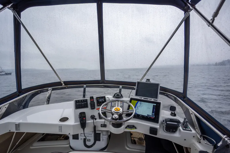 Slide: The Image of Helm of 2016 Cutwater 30 CB boat with navigation equipment on a rainy day. - 13