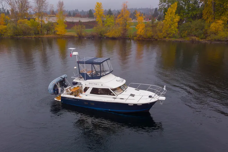 Slide: The Image of 2016 Cutwater 30 CB boat on calm water with autumn trees in the background. - 22