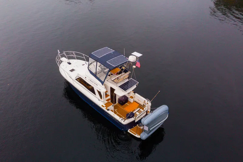 Slide: The Image of Aerial view of 2016 Cutwater 30 CB boat with solar panels on calm water. - 24