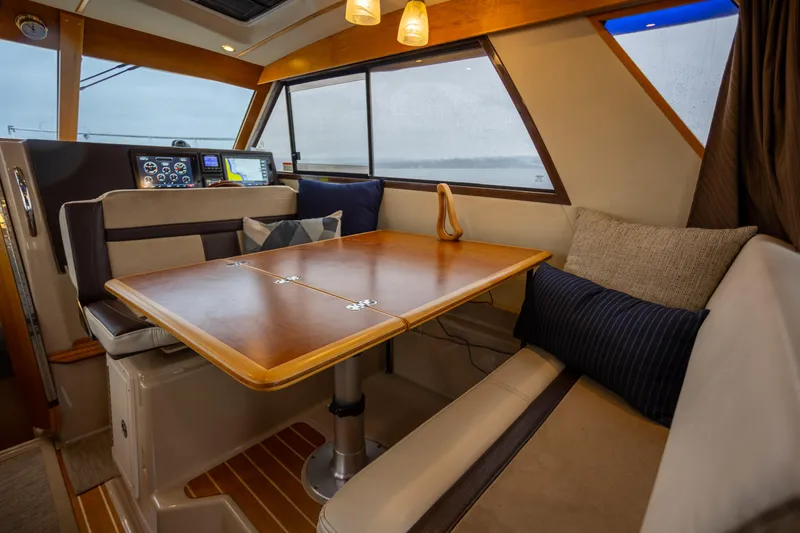 Slide: The Image of Interior of 2016 Cutwater 30 CB boat with dining area and navigation controls. - 4