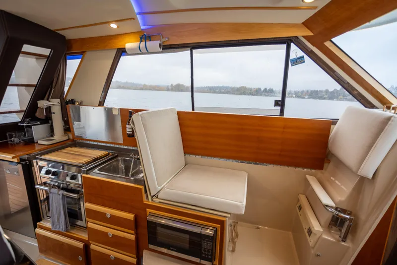 Slide: The Image of Interior of 2016 Cutwater 30 CB boat with kitchen and seating area. - 6