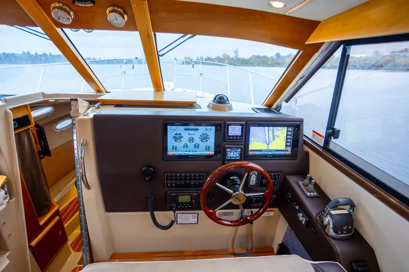 Slide: The Image of Helm of 2016 Cutwater 30 CB boat with advanced navigation displays and controls. - 8