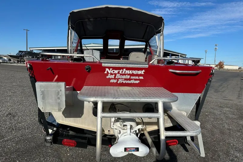 Slide: The Image of Red 2009 Northwest Jet 196 Freedom boat, rear view, parked outdoors. - 3