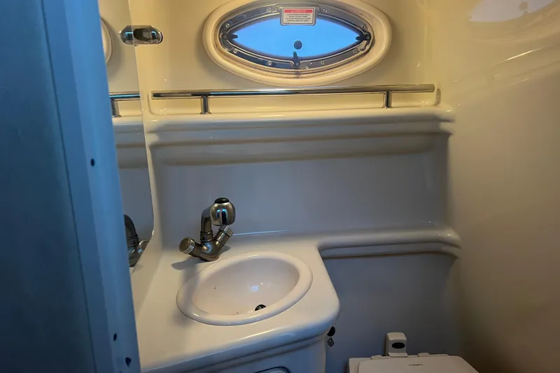 Slide: The Image of 2007 Sea Ray 260 Sundancer bathroom with sink and porthole window. - 13