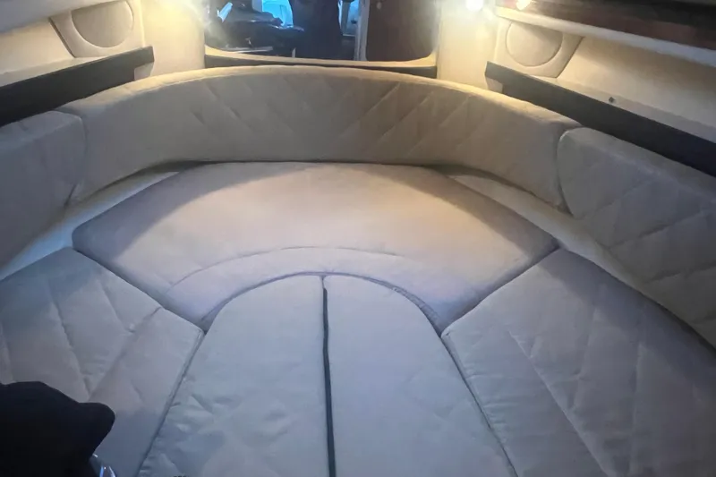 Slide: The Image of 2007 Sea Ray 260 Sundancer cabin interior with cushioned seating and ambient lighting. - 17