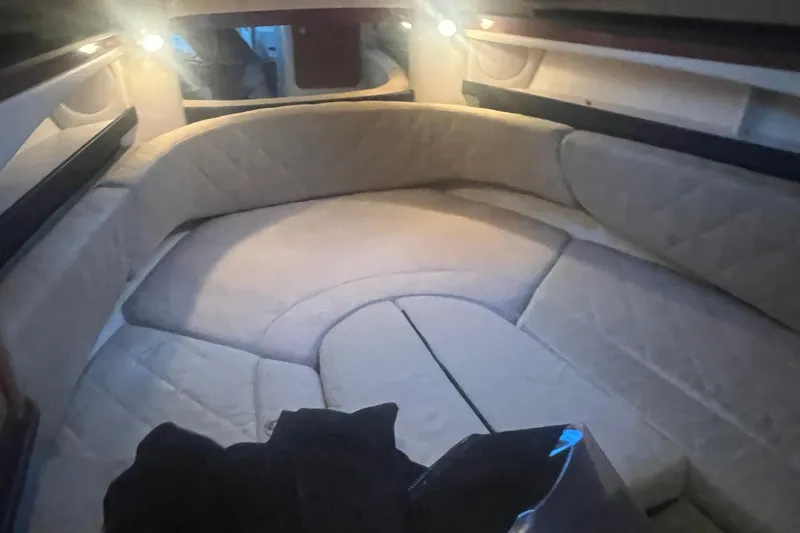 Slide: The Image of 2007 Sea Ray 260 Sundancer cabin interior with cozy seating and ambient lighting. - 18