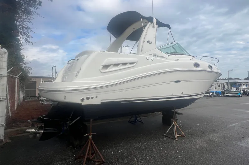 Slide: The Image of 2007 Sea Ray 260 Sundancer boat on stands in a marina setting. - 2