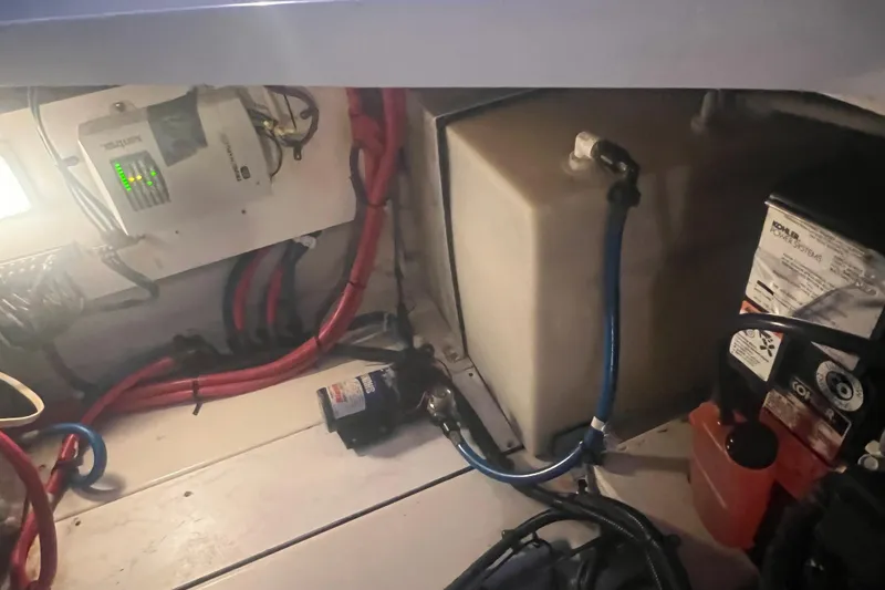 Slide: The Image of Engine compartment of a 2007 Sea Ray 260 Sundancer with wiring and components. - 28