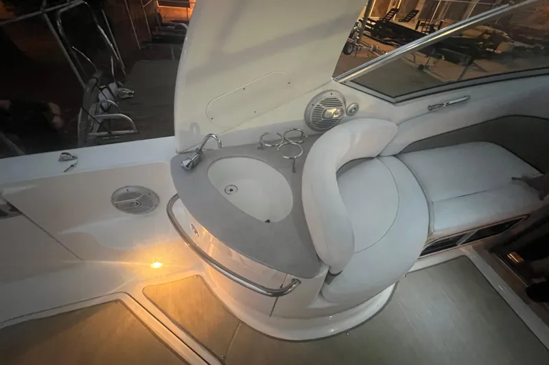 Slide: The Image of 2007 Sea Ray 260 Sundancer interior with sink, seating, and ambient lighting. - 33