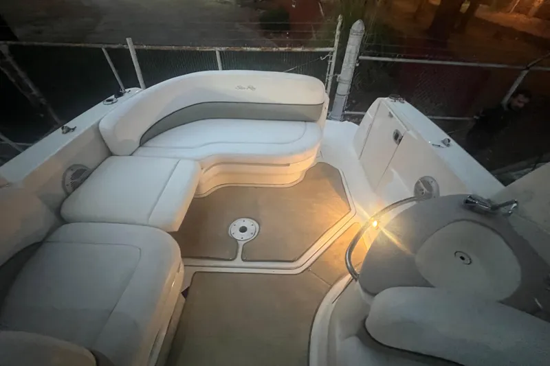 Slide: The Image of 2007 Sea Ray 260 Sundancer boat interior with cushioned seating and ambient lighting. - 34