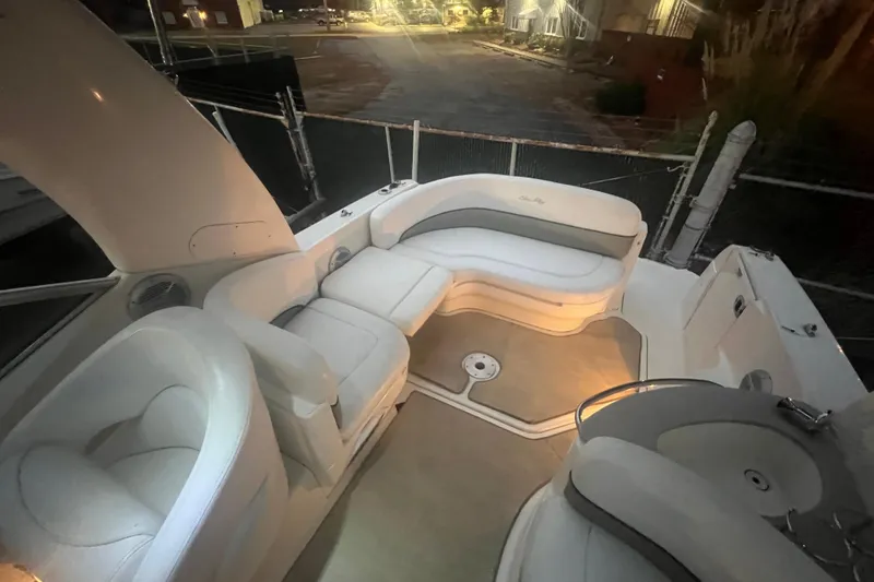 Slide: The Image of 2007 Sea Ray 260 Sundancer boat interior with white seating and ambient lighting. - 35