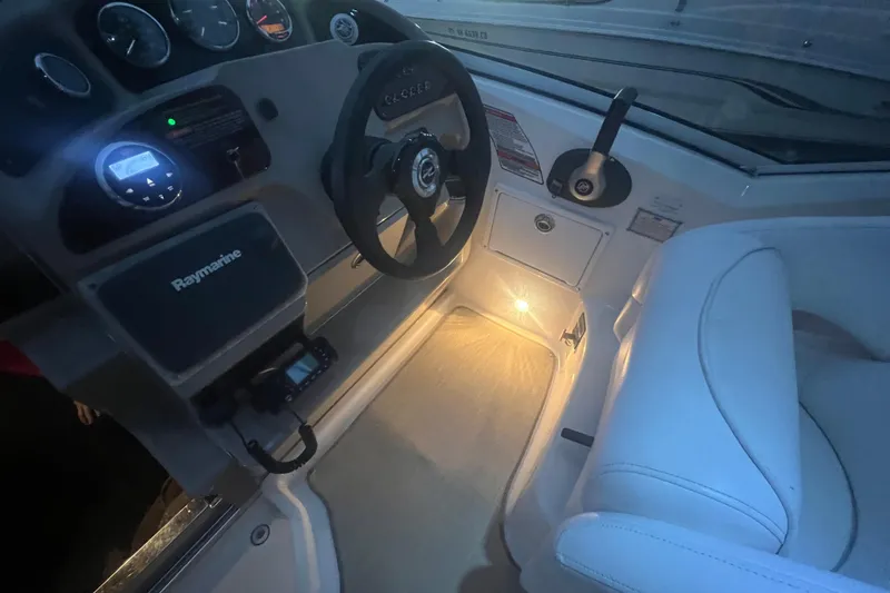 Slide: The Image of 2007 Sea Ray 260 Sundancer cockpit with illuminated controls and steering wheel. - 37