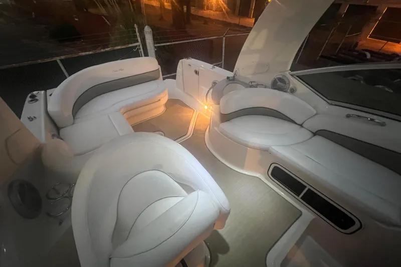 Slide: The Image of 2007 Sea Ray 260 Sundancer interior with white seating and ambient lighting. - 38