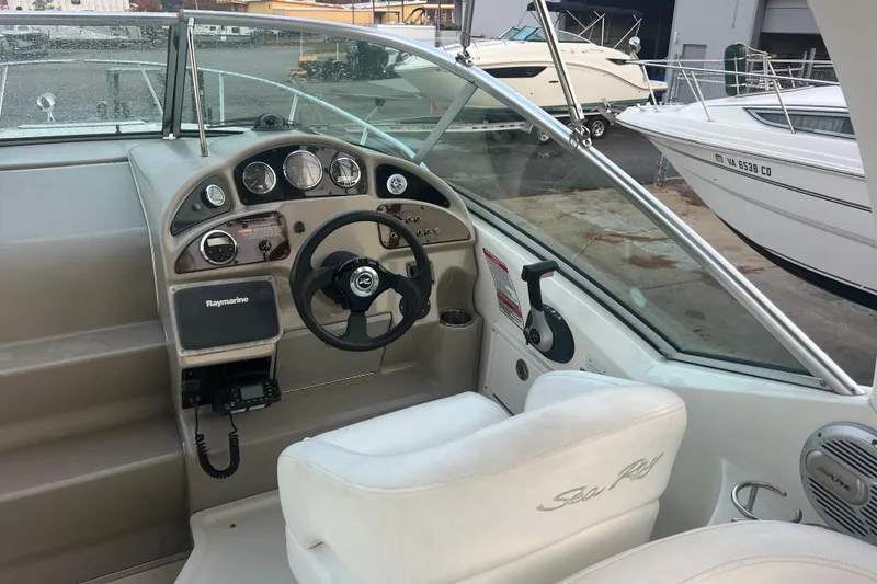 Slide: The Image of 2007 Sea Ray 260 Sundancer boat cockpit with steering wheel and control panel. - 4