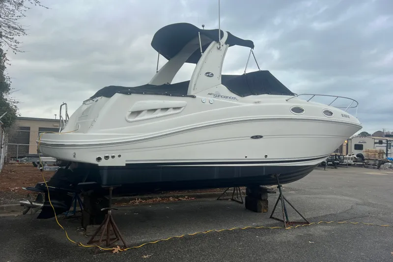 Slide: The Image of 2007 Sea Ray 260 Sundancer boat on stands, overcast sky background. - 46