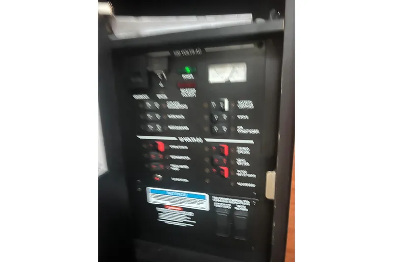 Slide: The Image of Electrical panel of a 2007 Sea Ray 260 Sundancer boat, showing various switches and controls. - 7