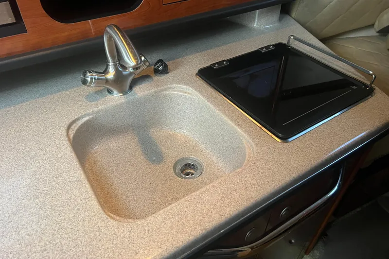 Slide: The Image of 2007 Sea Ray 260 Sundancer galley with sink and stove. - 9