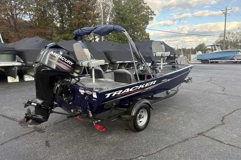 Slide: The Image of 2019 Tracker Pro 170 boat with Mercury engine in a parking lot. - 10