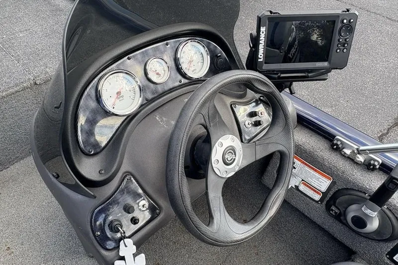 Slide: The Image of 2019 Tracker Pro 170 boat dashboard with steering wheel and navigation system. - 13