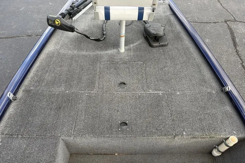 Slide: The Image of 2019 Tracker Pro 170 boat deck with trolling motor and carpeted surface. - 19