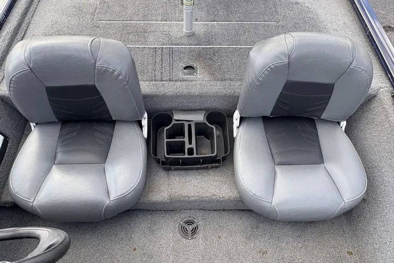Slide: The Image of 2019 Tracker Pro 170 boat interior with two gray seats and a central storage compartment. - 22