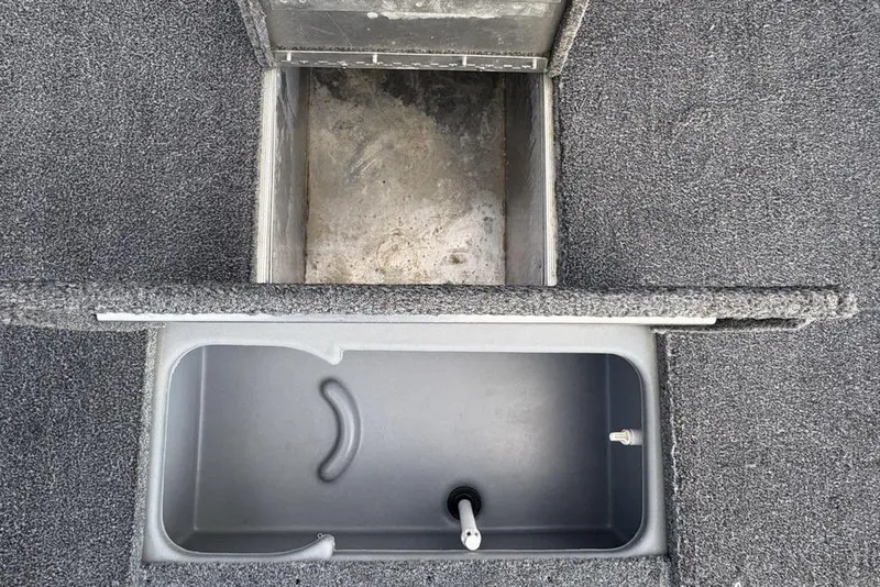 Slide: The Image of 2019 Tracker Pro 170 boat storage compartments with gray carpeted interior. - 27