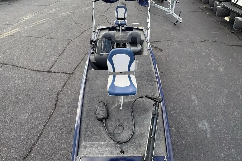 Slide: The Image of 2019 Tracker Pro 170 fishing boat with seating and trolling motor on asphalt surface. - 28