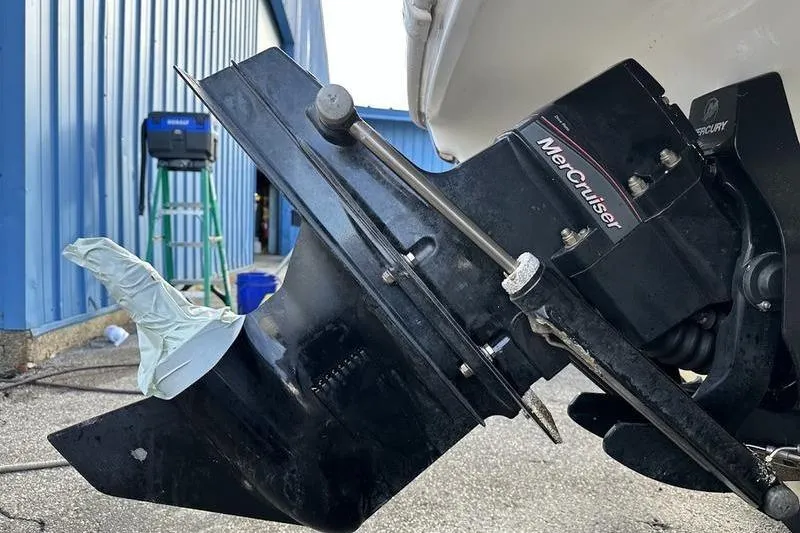 Slide: The Image of 2018 Tahoe 215 Xi boat with MerCruiser engine, dockside maintenance scene. - 12