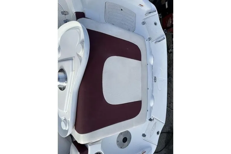 Slide: The Image of 2018 Tahoe 215 Xi boat interior with maroon and white seating. - 19