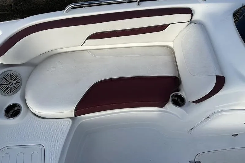 Slide: The Image of 2018 Tahoe 215 Xi boat interior with white and maroon seating. - 22