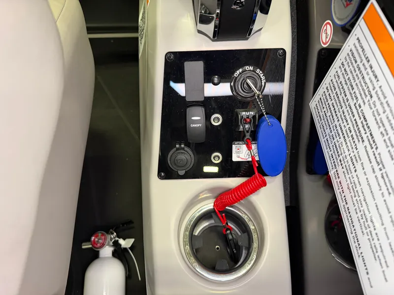 Slide: The Image of Close-up of a boat control panel with key switch, outlets, and fire extinguisher. - 24