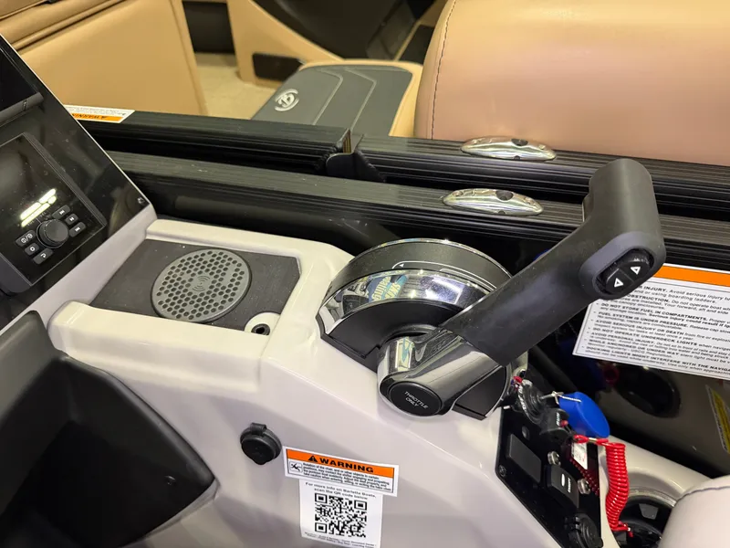 Slide: The Image of Close-up of the helm of a Barletta Cabrio 24 UE with throttle and controls. - 23