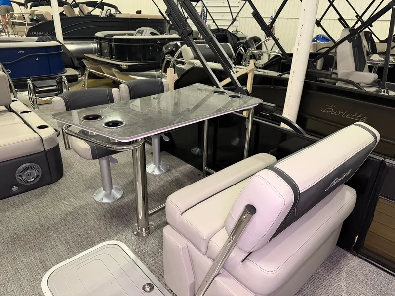 Slide: The Image of Interior of a Barletta Cabrio 24 UE with gray upholstered seats and a table with cup holders. - 30