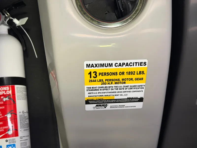 Slide: The Image of A label shows maximum capacity: 13 persons or 1892 pounds. A fire extinguisher is nearby. - 25