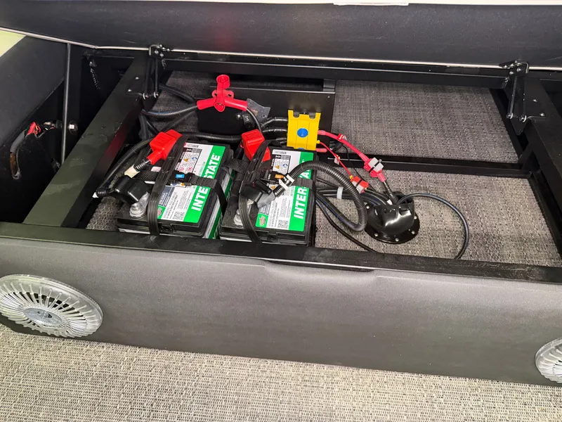 Slide: The Image of A battery compartment with two batteries and cables in a Barletta Cabrio 24 UE boat. - 38