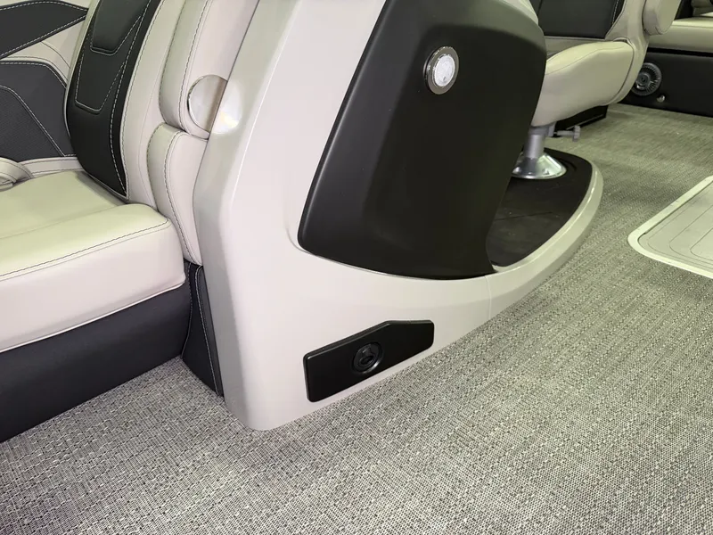 Slide: The Image of Close-up of a boat interior with beige and black seating on a textured flooring. - 13