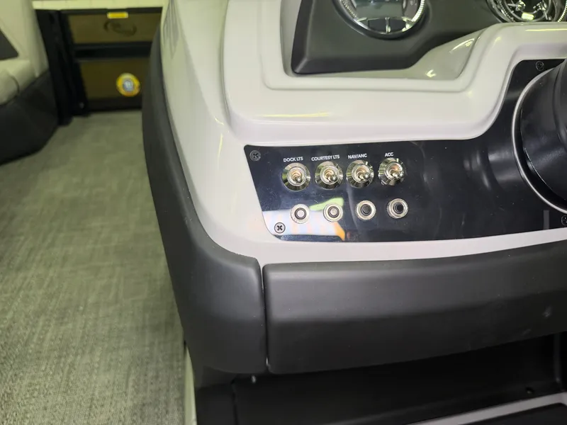 Slide: The Image of Close-up of a 2026 Barletta Cabrio 24 UE helm with switches and gauges. - 17